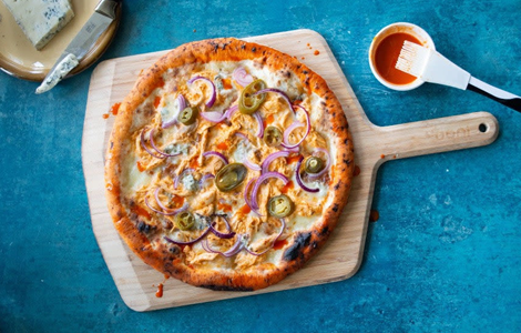 Spicy Cheese Pizza with Sauce on a Board Served at Pizza Daddy 
Blyth 